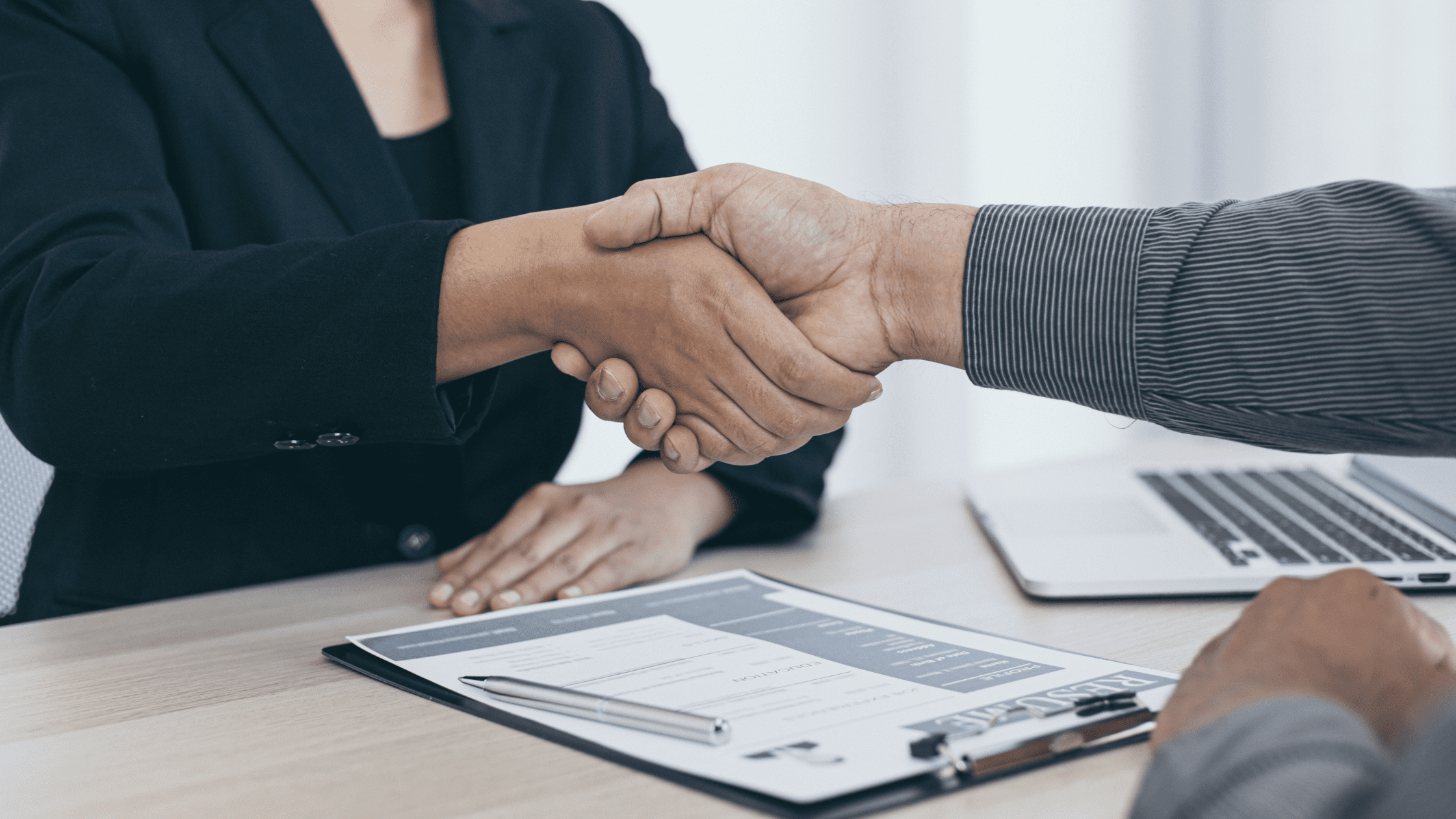 2 People shaking hands during an interview for NBME Free 120 Explanation